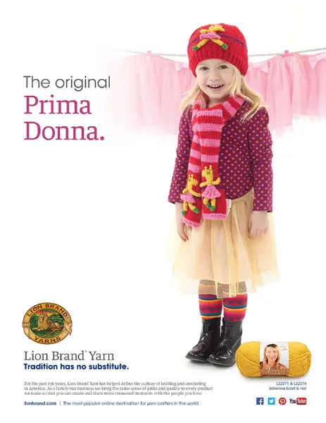 A young girl smiling and standing confidently. She is dressed in a colorful ensemble that includes a red knitted hat adorned with flowers, a purple polka-dot sweater over a pale yellow dress, and striped socks in red, yellow, and blue. She wears shiny black boots. The phrase "The original Prima Donna"