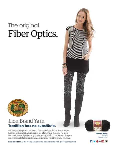A young woman styled in a modern, chic outfit featuring a black and white striped top with a solid black panel on the bottom, paired with black leggings adorned with a grey crochet pattern. She is wearing tall black boots and accessorized with bracelets. Her pose is casual with a hand on her hip, and she has a slight smile. The text "The original Fiber Optics."