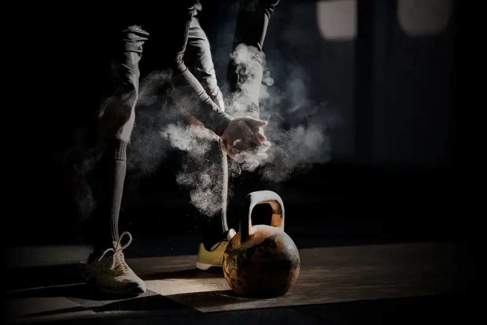 Athlete lifting a kettlebell.